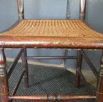 stencile worn on chairs edge