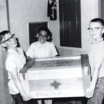 Three Children with Red Cross Trunk