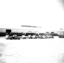 Exterior of Salinas Valley Vegetable Exchange lettuce shed. Trucks loaded w