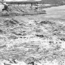 Close up view, looking downstream, of water coming through the spillway of