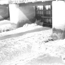 Close up view of water coming through the spillway gates of Laguna Dam.