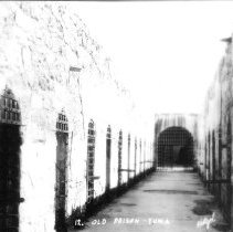 Interior of Yuma Prison showing hallway with cell doors branching off.