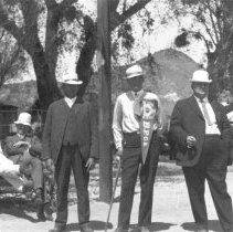 Group of men. One is wearing a banner that reads B.P.O.E. which stands for