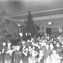 Elks Club Christmas tree. Crowd of children surrounding tree.