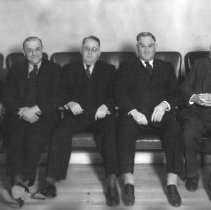 Five men sitting is chairs. Officers of the Elks Club?