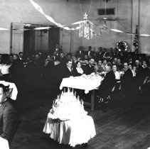 Elks Club birthday banquet / party. A cake, people at buffet tables.