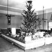 Elks club Christmas tree surrounded by tables with gifts for children on it