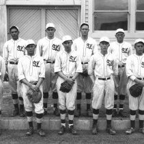 Valley Steam Laundry baseball team. Man in center wearing the suit is John