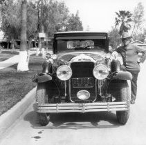 U.S. Customs officer standing by his patrol car.