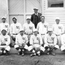 Valley Steam Laundry baseball team. Man in center wearing the suit is John