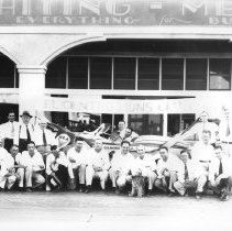 Group portrait of El Centro Lions Club members in front of a Gilmour car wh