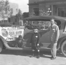 Car with sign that reads "Coming Buster Brown  And Trained Dog Tige Free Sh