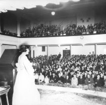 Miss Morrisey giving a concert at the Central High School auditorium.