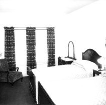 Interior of the Mayan Hotel showing guest room with twin beds.