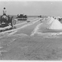 New Liverpool Salt Works - Men scraping salt. Small train in photo.