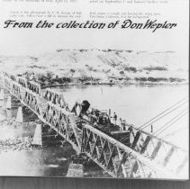 Railroad steam engine, with men standing on coal car, crossing the Colorado