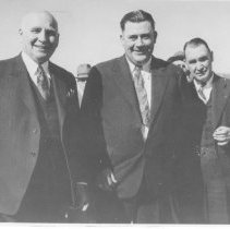 Ben Hulse standing with a small group of men. Ben is the man third from the