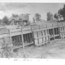 Sharps Heading. Wooden headgate with water flowing through.