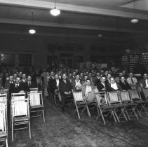 Interior of Tondro Auto Store showing a group of men meeting for a "dealers