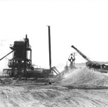 Batch plant for paving highway in sand dunes.