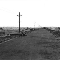 Man putting in wood guides for froming new highway through sand dunes.