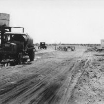 Water truck being filed from water tank.