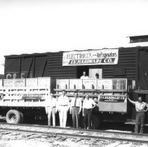 Imperial Valley Hardware Co. - Delivery trucks parking in front of railroad