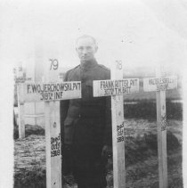 Claude Ritter standing by his brother's (Frank Ritter) grave in Germany.