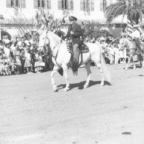 Elmer Heald riding a horse in a parade
