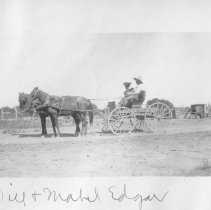 Will and Mabel Edgar sitting in a wagon / buggy.