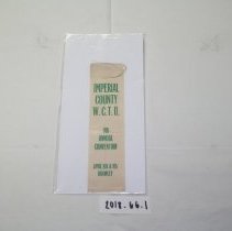 White ribbon with green lettering that reads: Imperial County W.C.T.U.
