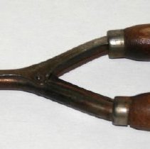 Hair curling iron. Metal with wooden handles.