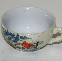 Tea cup to a child's tea set.