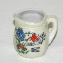 Cream pitchen to a child's tea set.