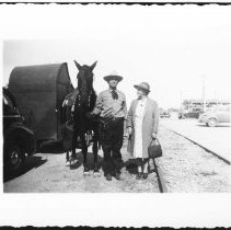 Hugh T. Osborne and Marion D. Osborne standing next to "Rayleig" their hors