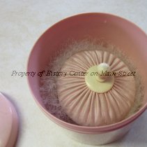 Pink Cosmetic jar, powder puff.