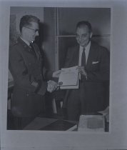 Untitled [Negative of William L. Bottorf receiving certificate from Brigadi