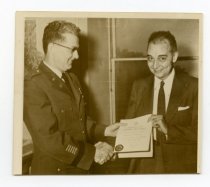 Untitled [Photograph of William L. Bottorf recieving certificate from Briga
