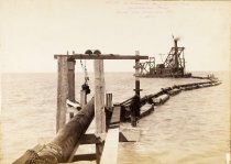 Untitled photograph of barge laying pipes