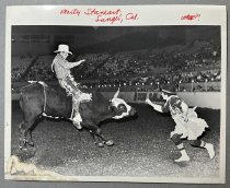 Untitled [Marty Staneart on Bucking Bull in Arena with Rodeo Clown], c. 198