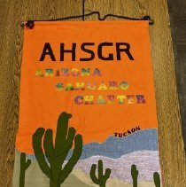Orange banner with rainbow lettering spelling "ARIZONA SAHUARO CHAPTER" and