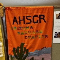 Orange banner with rainbow lettering spelling "ARIZONA SAHUARO CHAPTER" and