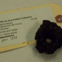 [Solidified Volcanic Magma with Inset Coin]