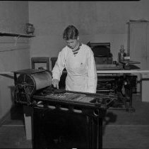 Hamilton High School Activities, Industrial Arts: Student putting ink on type, 1949