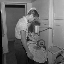 Hamilton High School Activities, Industrial Arts: Student buffing a tray, 1