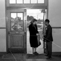 Jordan high school activities.  Student greeting visitor at school entrance.