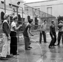 Virgil junior high school activities.  Club leader supervises boys’ basketball game.