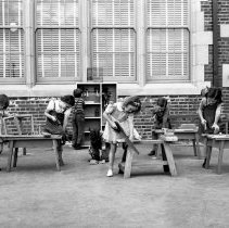 109th St. school activities.   First grade group making boats for their har