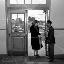 Jordan high school activities.  Student greeting visitor at school entrance