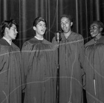 Jordan high school activities.  Boys’ quartet singing into microphone.